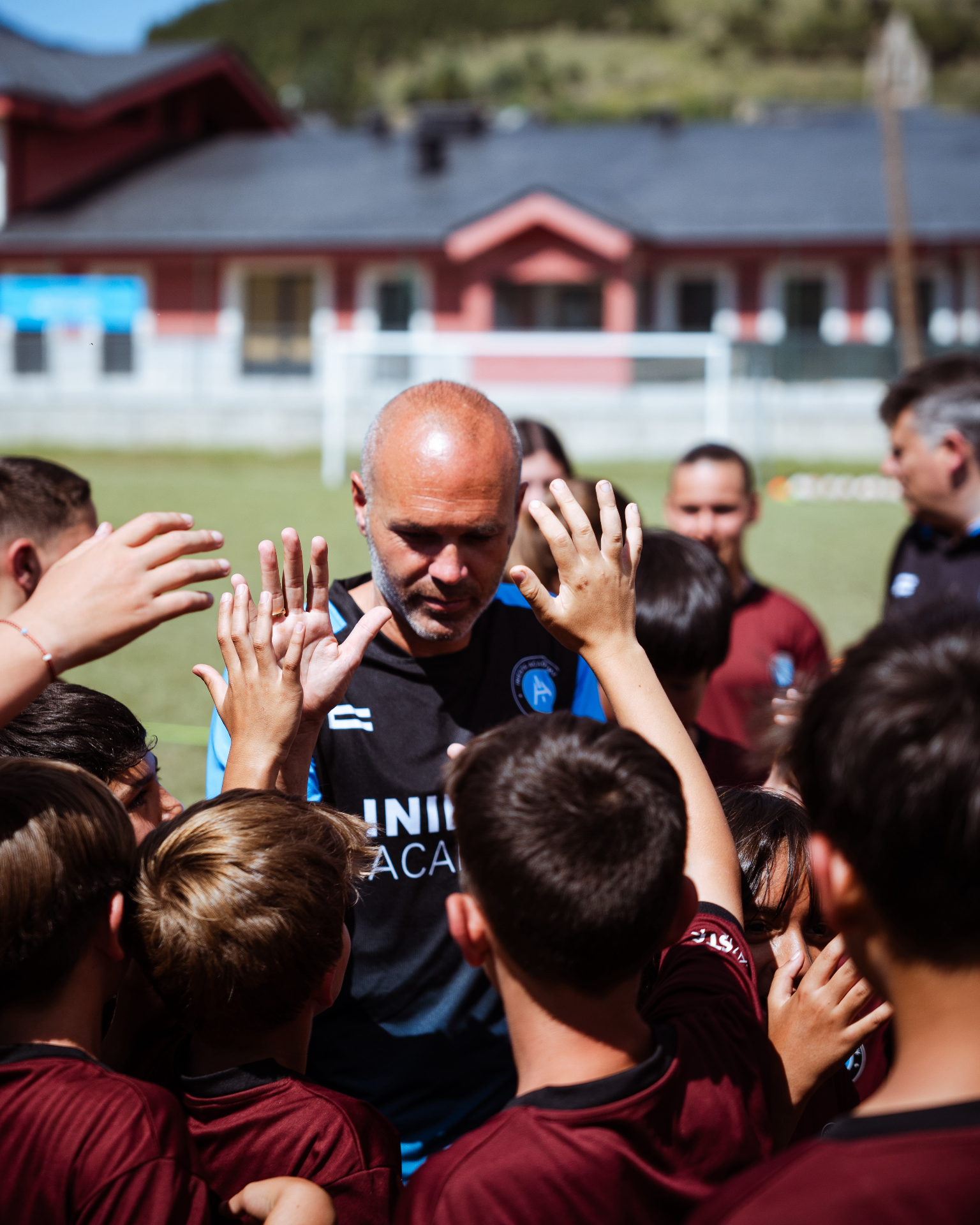 Andrés Iniesta with young academy players